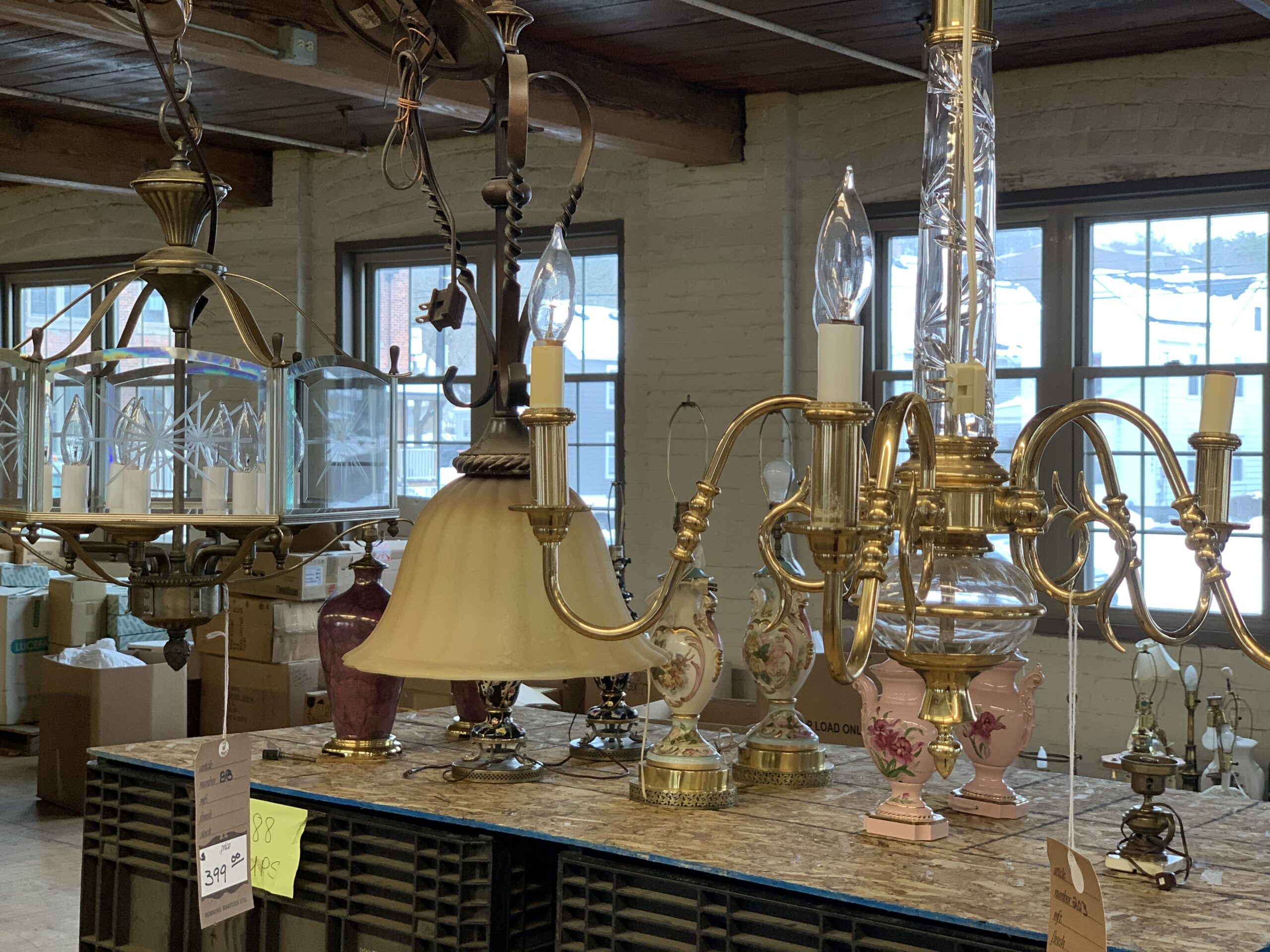 Goods Store Holding Vintage Lamp & Light Sale